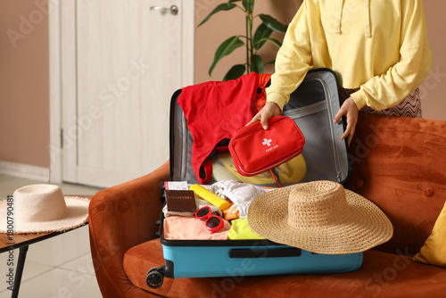 Young woman with suitcase a...
