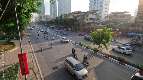 Wide urban street scene showing busy traffic in Hanoi, Vietnam.