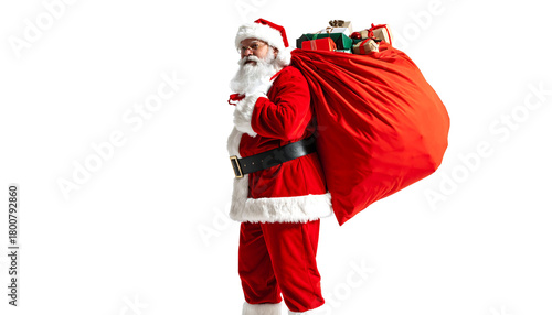Santa claus in red suit carrying a large sack full of gifts and presents over his shoulder, isolated on white