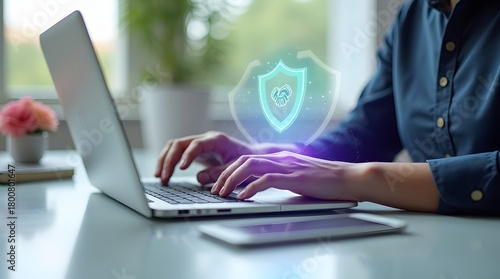 Protecting Digital Data A Detailed Look at Online Security with a Person Typing on a Laptop and a Glowing Shield Icon