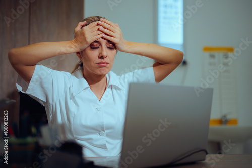 Desperate Doctor Feeling Worried about the Digital Bureaucracy. Unhappy exasperated medical practitioner using her laptop