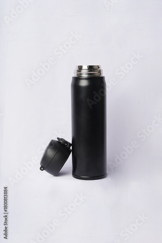 The open lid reveals the top of the bottle, adding a subtle detail to the simple composition