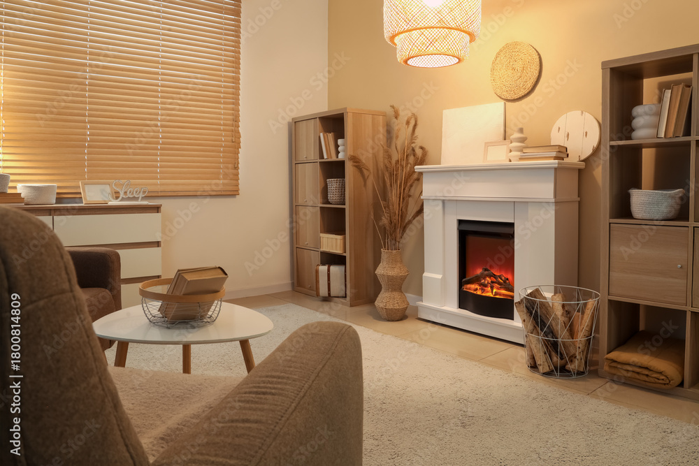 Fototapeta premium Interior of cozy living room with fireplace, armchair and coffee table