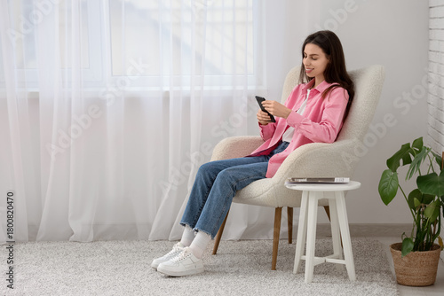 Young woman using mobile ph...