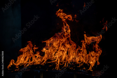 Fire blaze flames on black background. Fire burn flame isolated, abstract texture. Flaming explosion with burning effect. Fire wallpaper, abstract art pattern with copy space.