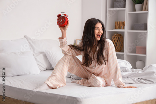 Happy young woman with alar...
