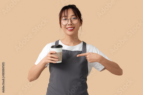 Female barista with cup of ...