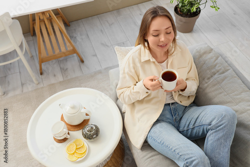 Young woman with cup of tea...