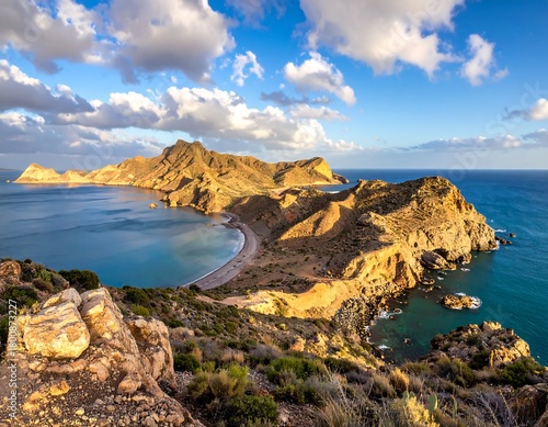 Aerial view of mountainous coastline with turquoise water under a blue sky