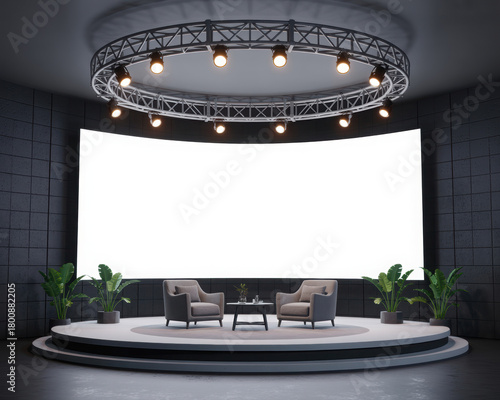Modern stage with blank screen featuring two armchairs and plants ideal for presentations or interviews