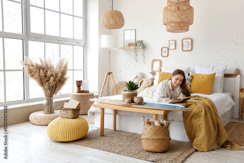 Young woman reading book wi...