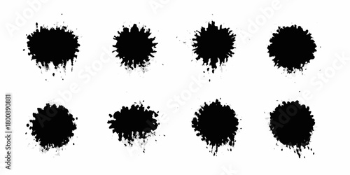 Collection of eight black ink splatter brush strokes on a white background