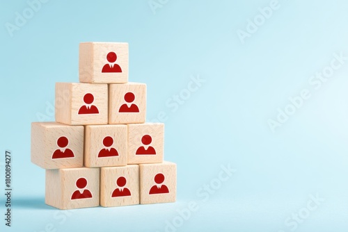 Pyramid of People: A symbolic pyramid is constructed using wooden blocks, each bearing the icon of an individual, representing the concepts of team, hierarchy, and organizational structure. 