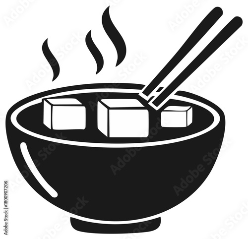 Steaming bowl of soup with tofu cubes and chopsticks