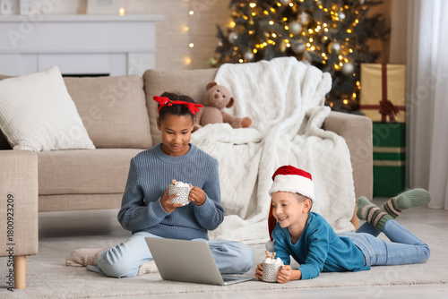 Cute children with laptop a...