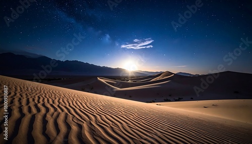 Fototapeta Naklejka Na Ścianę i Meble -  A mesmerizing nightscape showcases desert dunes under a starlit sky, illuminated by a bright celestial body's radiant glow