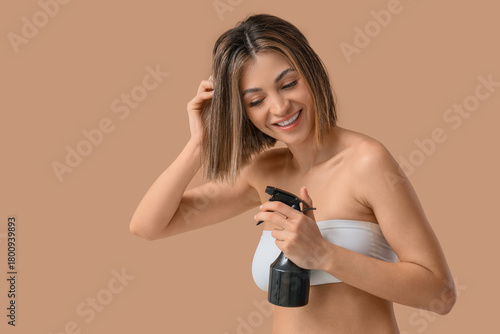 Happy young woman applying ...