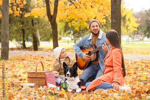 Happy family with dog playi...
