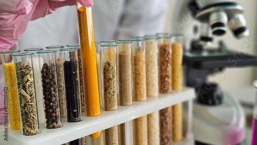Photos Test tubes containing various grains for developing GMO products in a biochemistry lab