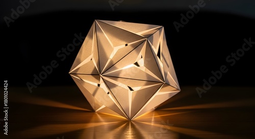 A modern geometric sculpture with intricate facets and warm lighting, placed on a reflective surface against a dark background, showcasing contemporary art and design