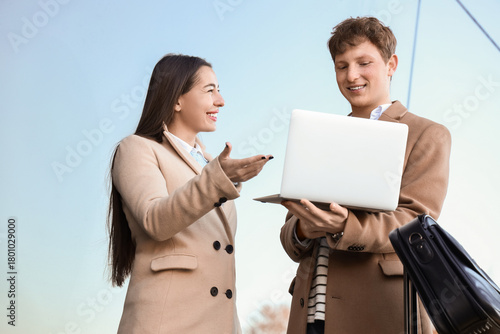 Young couple using laptop n...