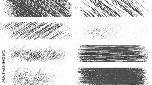 Collection of eight dark grey textured grunge brush stroke and splatter graphic elements on white background