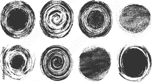 Eight black circular grunge textures with brush stroke and speckle effects on white background abstract