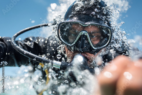 Professional diver entering water with perfect technique
