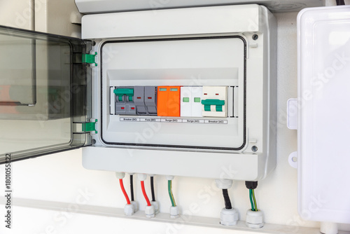 Solar Combiner Box on a House Wall with Integrated DC and AC Safety Components (Breakers, Fuses, Surge Protection) for a Hybrid PV System.