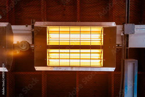 Industrial Radiant Heater With Grid Guard Illuminated Tubular Lamps In Ceiling Fixture