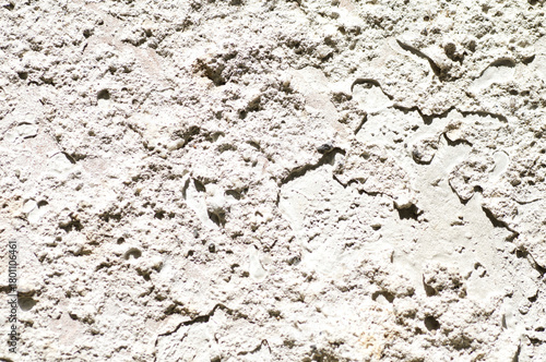 Bild auf Leinwand Close-Up Of Rough Light Beige Rock Surface With Texture, Cracks, And Shadows