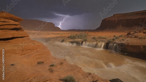 cinematic view of a desert wadi suddenly filling with roaring water after distant lightning