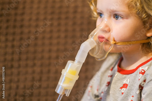 Child with nebulizer. Kid receiving medical treatment for respiratory illness. Health care and medical procedure for bronchitis or asthma.