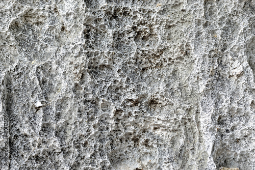 texture of gray stone surface with rough natural patterns and depth. Ideal for use as a background or design texture, close-up