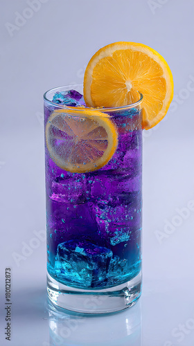 Layered purple and blue cocktail with glowing ice cubes and orange slice garnish in tall glass