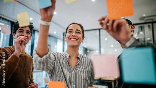 Wallpaper Mural Team laughs around sticky notes during upbeat ideation session in bright office Torontodigital.ca