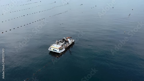 researchers meticulously obtain water samples under calm aquatic farms using drone surveillance technology
