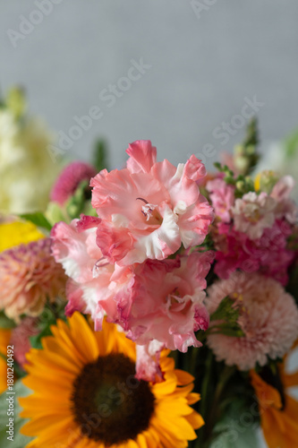 Vibrant floral bouquet with gladiolus, sunflower, and chrysanthemums