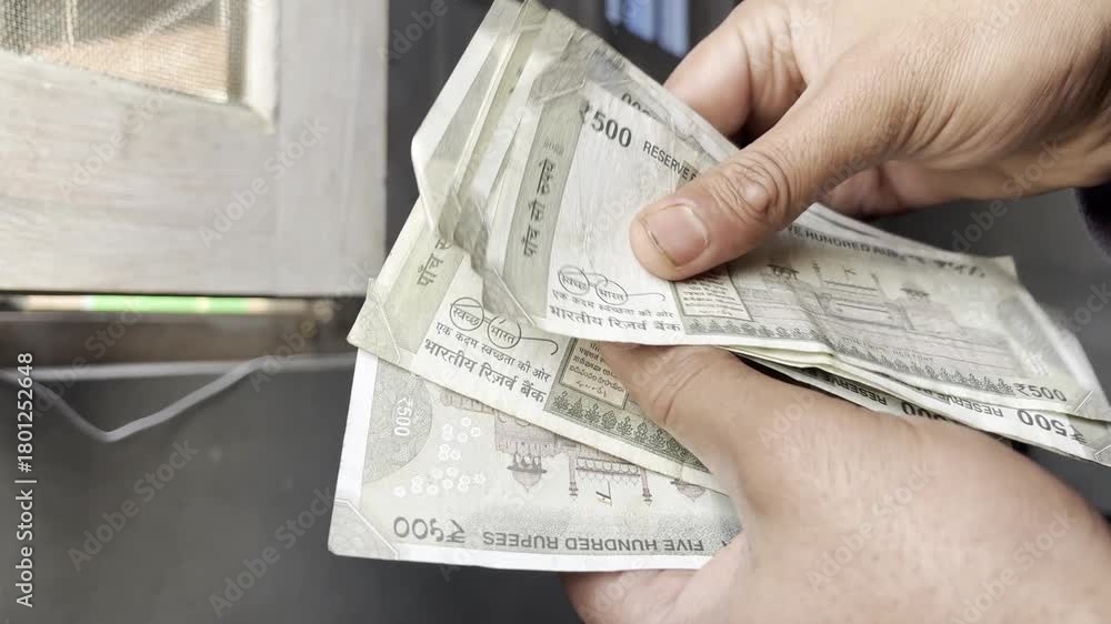 Counting Ruppes Cash Closeup footage of hands counting cash and money. An employee counting ...