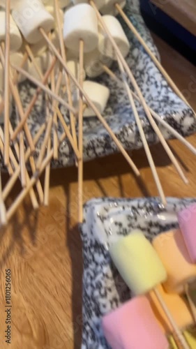 vertical video of colorful pastel marshmallow sticks on skewers showing sweet playful snack style
