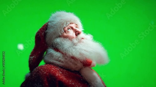 Santa Claus looking up at snowfall on empty green screen. Chroma key. Mockup Template: Jolly Santa Claus Standing On Green Screen Chromakey Background And Inviting Guests To Magical Workshop On Christ