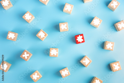 Puzzle pieces on wooden cubes, blue background. solution concept.
