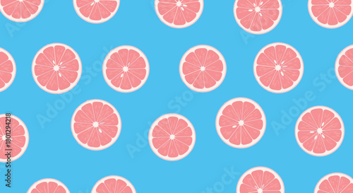 Vibrant seamless pattern featuring refreshing pink grapefruit slices evenly distributed on a bold and bright blue background.