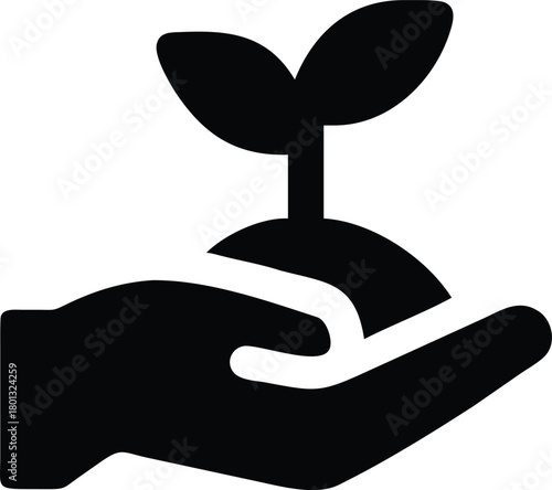 A gentle hand delicately holds a young plant sprouting from a mound