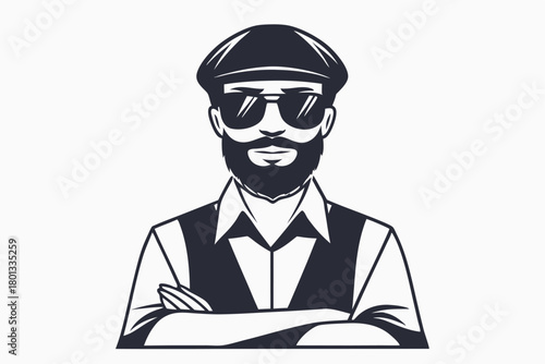 Bearded man wearing a cap and sunglasses confidently crosses his arms while posing