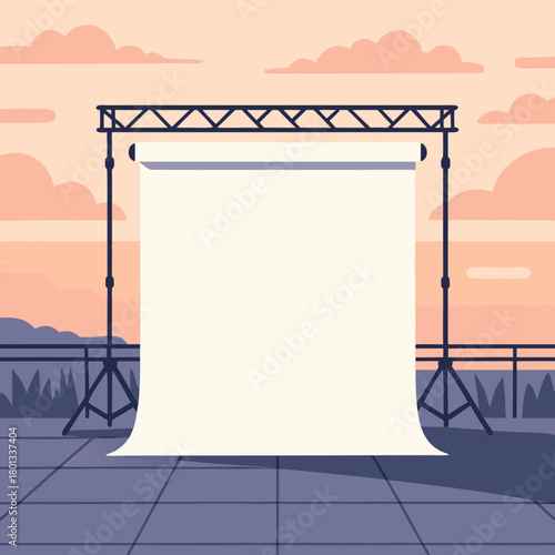 Outdoor event stage with large hanging fabric screen and metal frame at sunset, open empty area ready for concerts, presentations, festivals and public gatherings