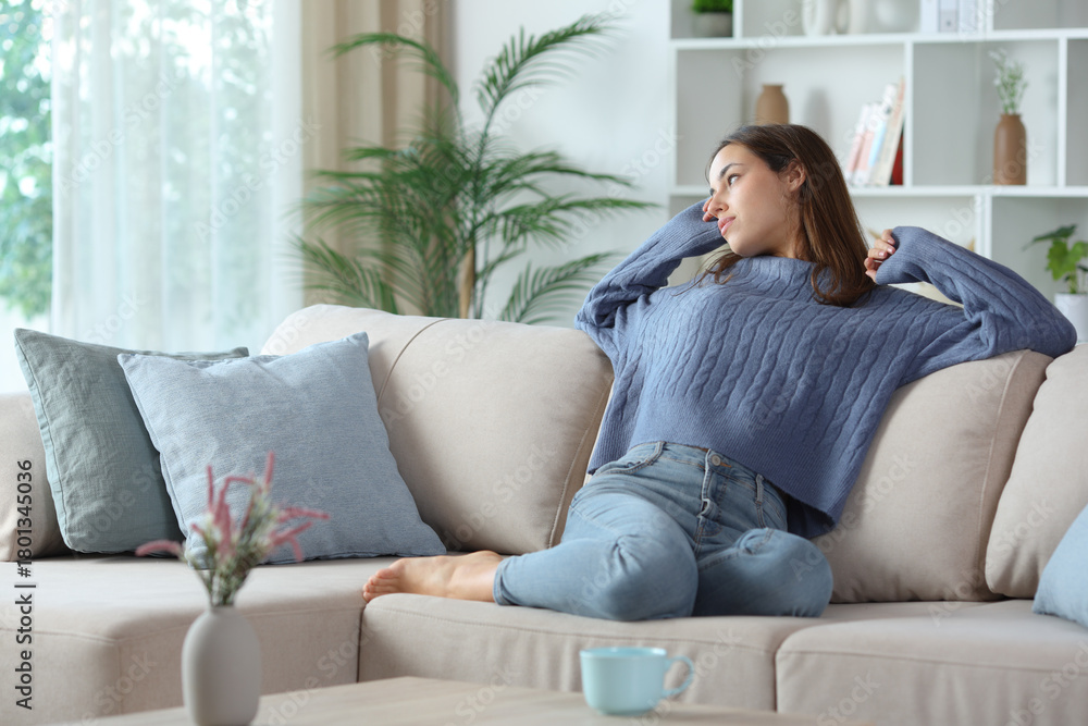 Obraz premium Woman in blue stretching at home