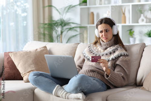Suspicious woman in winter buying media online at home