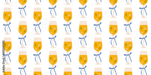 Colorful glasses of juice with ribbons arranged in a playful pattern on a white background for a festive vibe