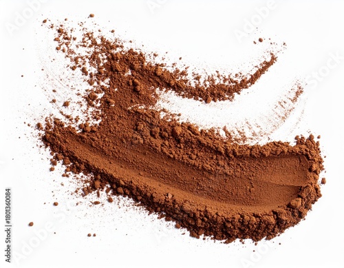 ** Cocoa powder spread on a white surface, highlighting its texture and rich brown color, perfect for culinary and artistic applications. **